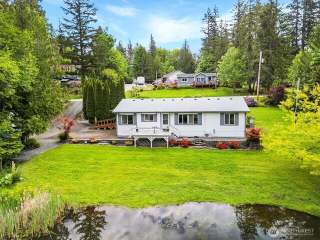 495 Lakeside Dr, Sedro Woolley, WA 98284 - rear view of property with a lawn, a deck, and view of wooded area