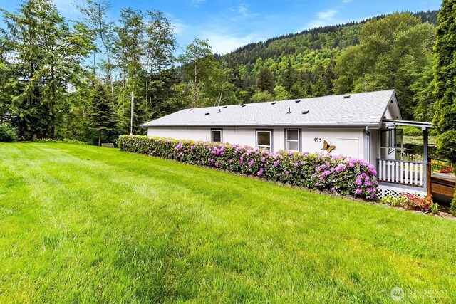 495 Lakeside Dr, Sedro Woolley, WA 98284 - view of side of home with a wooded view, a lawn, and a wooden deck