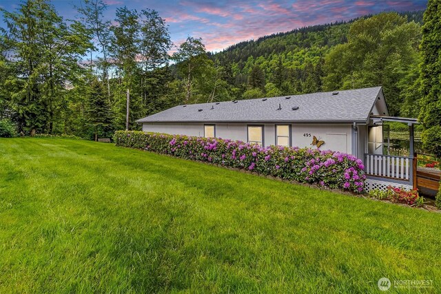 495 Lakeside Dr, Sedro Woolley, WA 98284 - property exterior at dusk featuring a forest view, a lawn, and roof with shingles