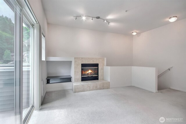 15325 SE 155th Pl Unit N5, Renton, WA 98058 - unfurnished living room featuring carpet, a tile fireplace, and baseboards