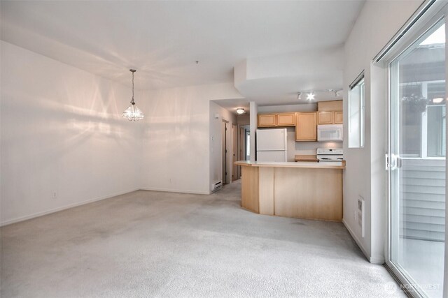 15325 SE 155th Pl Unit N5, Renton, WA 98058 - kitchen featuring white appliances, light brown cabinets, light carpet, a peninsula, and a chandelier