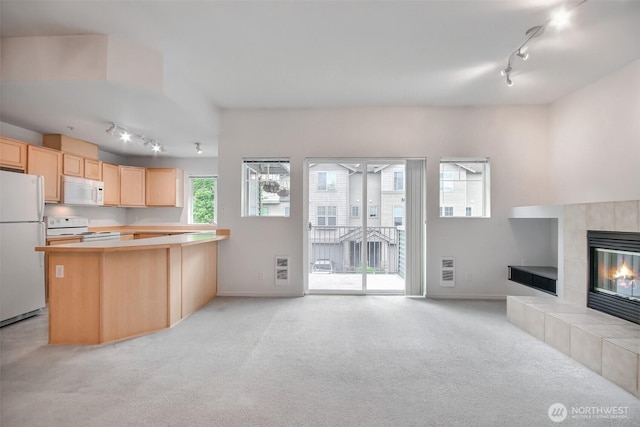 15325 SE 155th Pl Unit N5, Renton, WA 98058 - kitchen with track lighting, white appliances, open floor plan, light brown cabinetry, and light carpet