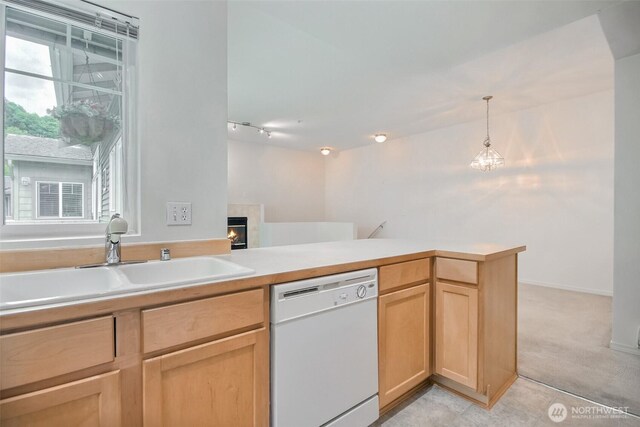15325 SE 155th Pl Unit N5, Renton, WA 98058 - kitchen with dishwasher, a sink, light brown cabinetry, a lit fireplace, and light countertops