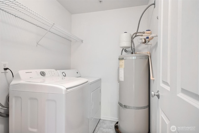15325 SE 155th Pl Unit N5, Renton, WA 98058 - washroom featuring secured water heater, washer and clothes dryer, and light tile patterned floors