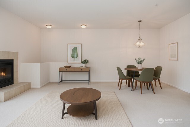 15325 SE 155th Pl Unit N5, Renton, WA 98058 - living room with carpet flooring, a chandelier, baseboards, and a fireplace