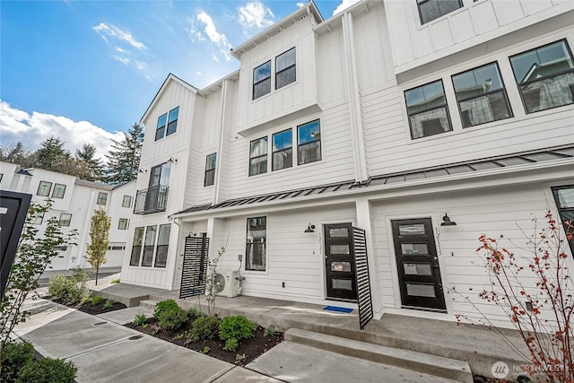 12111 127th Avenue Ct E Unit 92, Puyallup, WA 98374 - townhome / multi-family property featuring a standing seam roof, board and batten siding, and metal roof