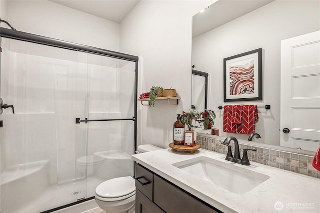12111 127th Avenue Ct E Unit 92, Puyallup, WA 98374 - full bathroom featuring a stall shower, backsplash, toilet, and vanity