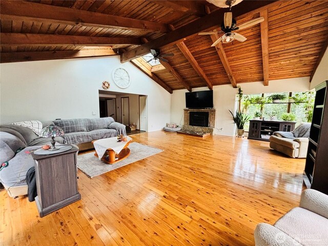 1311 SW Lake Roesiger Rd, Snohomish, WA 98290 - living room featuring a ceiling fan, wood-type flooring, wooden ceiling, and a fireplace