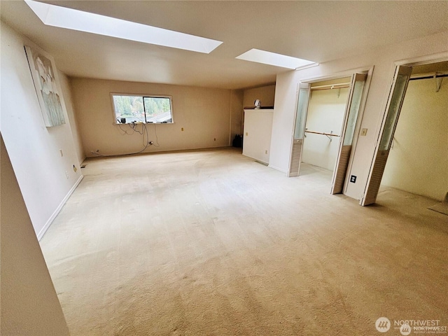 1311 SW Lake Roesiger Rd, Snohomish, WA 98290 - unfurnished bedroom featuring a skylight, two closets, and light carpet
