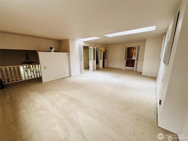 1311 SW Lake Roesiger Rd, Snohomish, WA 98290 - empty room featuring a skylight and light colored carpet