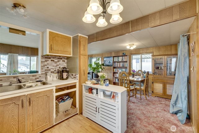 18501 52nd Ave W Unit 44, Lynnwood, WA 98037 - kitchen featuring a sink, a chandelier, light countertops, plenty of natural light, and wooden walls