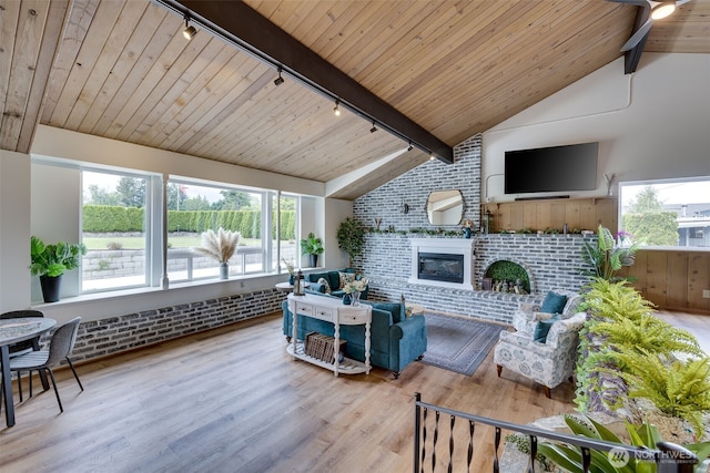 18501 52nd Ave W Unit 44, Lynnwood, WA 98037 - living room with rail lighting, wood ceiling, wood finished floors, a brick fireplace, and brick wall