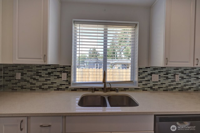 2201 303rd Pl, Ocean Park, WA 98640 - kitchen featuring dishwashing machine, a sink, white cabinets, and light countertops