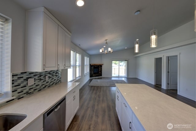 2201 303rd Pl, Ocean Park, WA 98640 - kitchen with stainless steel dishwasher, dark wood finished floors, white cabinets, tasteful backsplash, and lofted ceiling