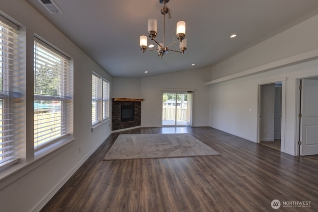 2201 303rd Pl, Ocean Park, WA 98640 - unfurnished living room with a chandelier, wood finished floors, baseboards, a glass covered fireplace, and lofted ceiling