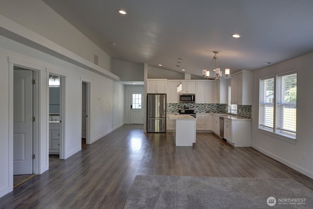 2201 303rd Pl, Ocean Park, WA 98640 - kitchen with appliances with stainless steel finishes, a chandelier, recessed lighting, vaulted ceiling, and white cabinetry