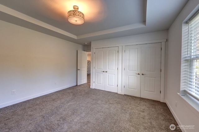 2201 303rd Pl, Ocean Park, WA 98640 - unfurnished bedroom with carpet flooring, a raised ceiling, baseboards, and a closet