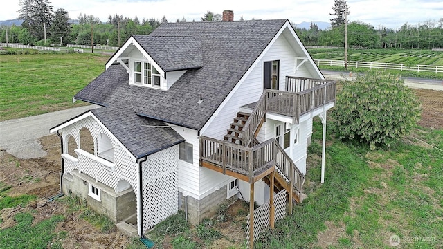 27120 36th Ave NW, Stanwood, WA 98292 - view of side of property featuring roof with shingles, a chimney, a deck, and stairway