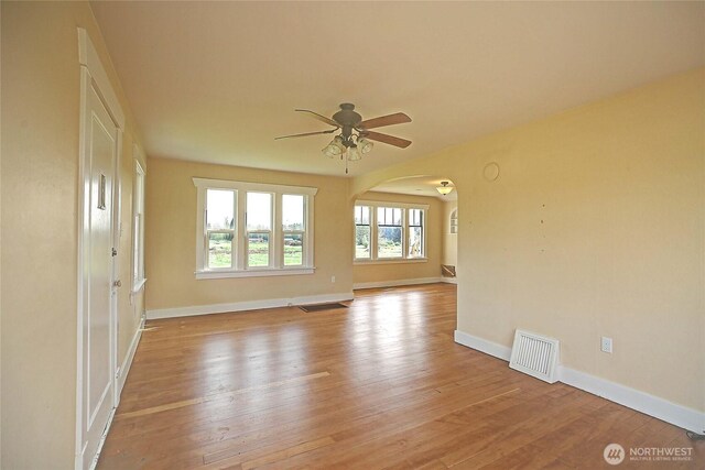 27120 36th Ave NW, Stanwood, WA 98292 - spare room with arched walkways, ceiling fan, and wood-type flooring