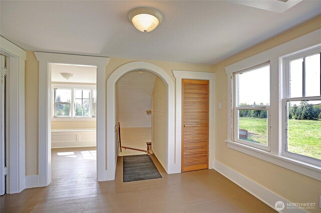 27120 36th Ave NW, Stanwood, WA 98292 - hallway featuring baseboards, arched walkways, and wood finished floors