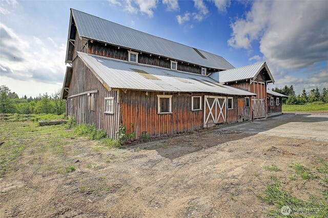 27120 36th Ave NW, Stanwood, WA 98292 - rear view of house featuring metal roof, a barn, and an outbuilding