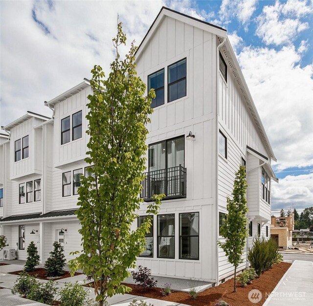 12119 127th Avenue Ct E Unit 94, Puyallup, WA 98374 - view of home's exterior with board and batten siding, a balcony, and ac unit