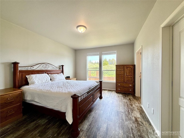 642 Weatherwax Loop NE, Ocean Shores, WA 98569 - bedroom with dark wood-style flooring and baseboards