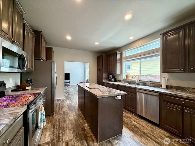 642 Weatherwax Loop NE, Ocean Shores, WA 98569 - kitchen featuring appliances with stainless steel finishes, a sink, a center island, dark brown cabinets, and recessed lighting