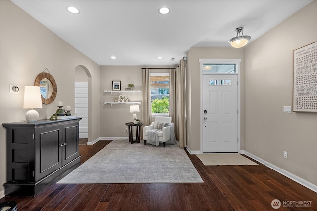 11226 Borgen Loop, Gig Harbor, WA 98332 - entrance foyer with arched walkways, dark wood finished floors, and recessed lighting