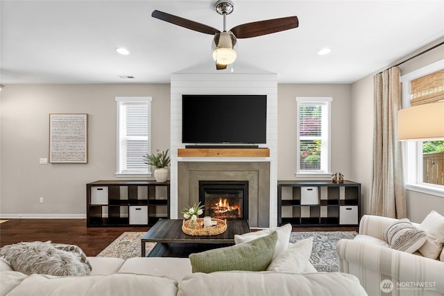 11226 Borgen Loop, Gig Harbor, WA 98332 - living room with dark wood-type flooring, ceiling fan, a fireplace, healthy amount of natural light, and recessed lighting