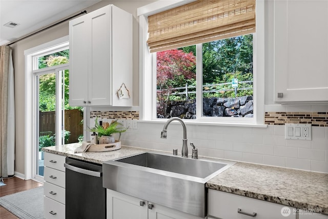11226 Borgen Loop, Gig Harbor, WA 98332 - kitchen featuring dishwashing machine, white cabinets, backsplash, and light stone countertops