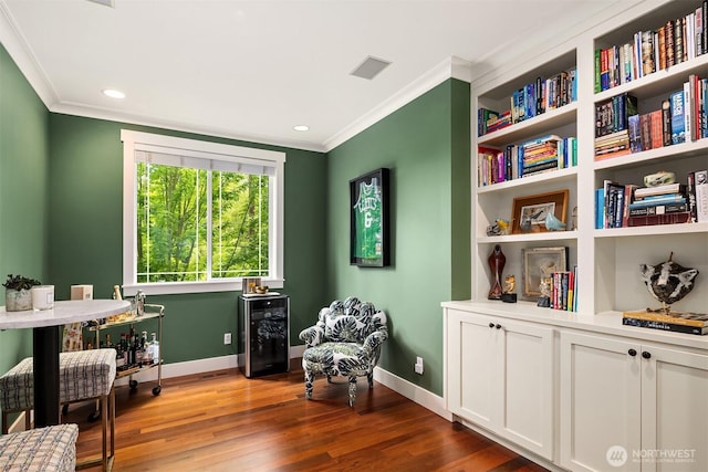 5102 S Frontenac St, Seattle, WA 98118 - living area with crown molding, dark wood finished floors, beverage cooler, baseboards, and recessed lighting