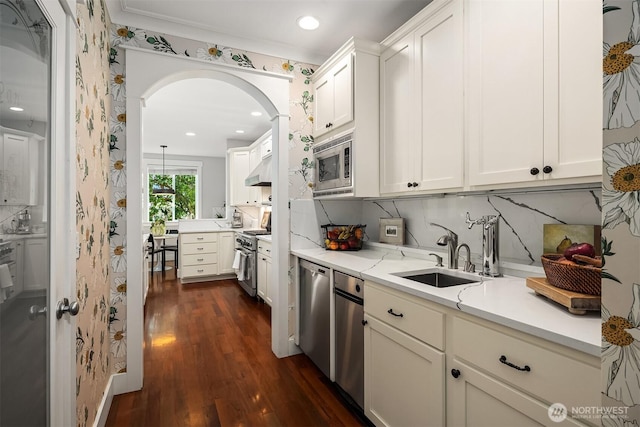5102 S Frontenac St, Seattle, WA 98118 - kitchen with a sink, stainless steel appliances, arched walkways, dark wood-type flooring, and recessed lighting