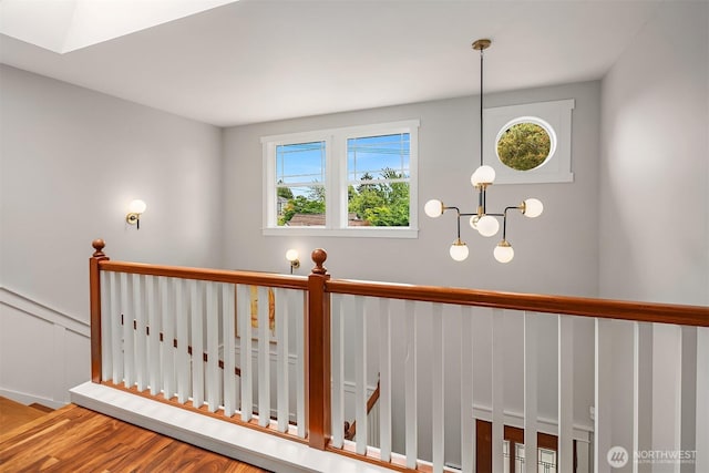 5102 S Frontenac St, Seattle, WA 98118 - stairway featuring healthy amount of natural light, a chandelier, and wood finished floors