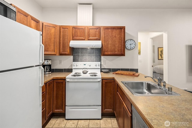 5102 S Frontenac St, Seattle, WA 98118 - kitchen with white appliances, under cabinet range hood, a sink, backsplash, and brown cabinets