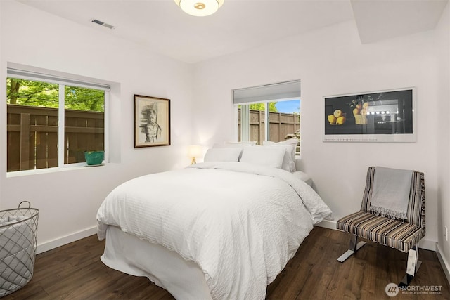 5102 S Frontenac St, Seattle, WA 98118 - bedroom with multiple windows, baseboards, and wood finished floors