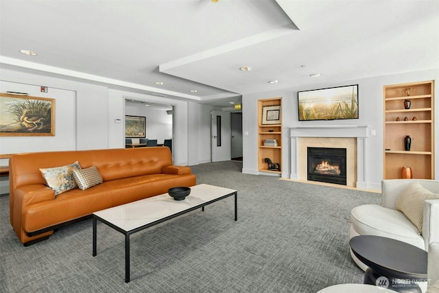 225 4th Ave Unit A307, Kirkland, WA 98033 - living area featuring carpet floors, a fireplace with flush hearth, recessed lighting, built in shelves, and baseboards