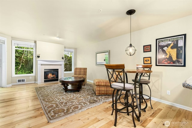 225 4th Ave Unit A307, Kirkland, WA 98033 - living room with hardwood / wood-style flooring, a glass covered fireplace, and baseboards