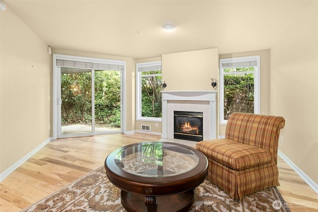 225 4th Ave Unit A307, Kirkland, WA 98033 - sitting room with wood finished floors, a fireplace with flush hearth, and baseboards