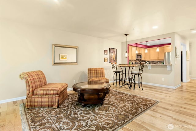 225 4th Ave Unit A307, Kirkland, WA 98033 - living area with light wood-style floors and baseboards