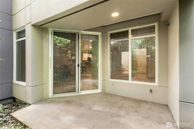 225 4th Ave Unit A307, Kirkland, WA 98033 - doorway to property featuring a patio and stucco siding