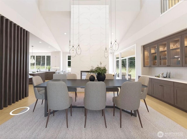 12925 NE 70th Ln, Kirkland, WA 98033 - dining space featuring light wood-style flooring, high vaulted ceiling, and recessed lighting