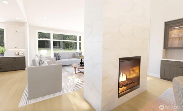 12925 NE 70th Ln, Kirkland, WA 98033 - living area with light wood-style floors, a premium fireplace, and recessed lighting