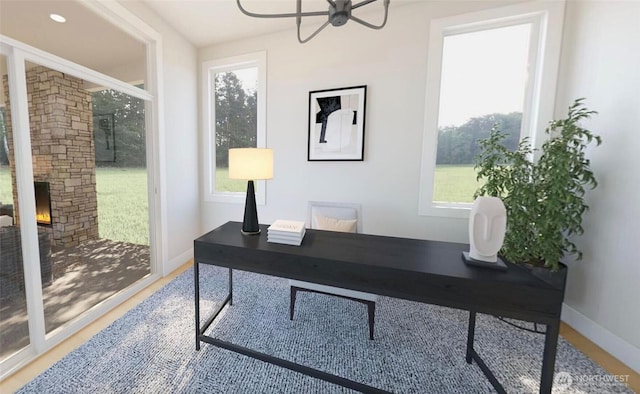 12925 NE 70th Ln, Kirkland, WA 98033 - home office featuring baseboards, a ceiling fan, and a stone fireplace