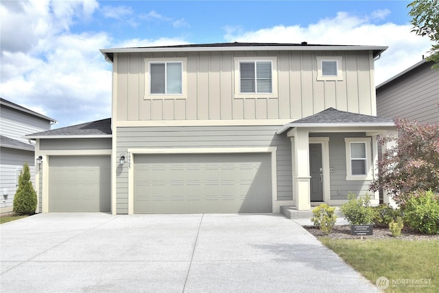 traditional home featuring concrete driveway, board and batten siding, and an attached garage