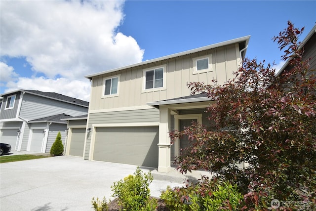 traditional-style house featuring board and batten siding, driveway, and an attached garage