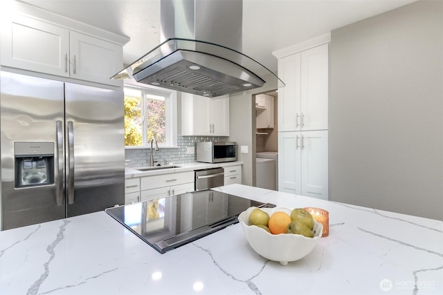 17801 111th Ave SE, Renton, WA 98055 - kitchen featuring appliances with stainless steel finishes, island range hood, a sink, backsplash, and white cabinets