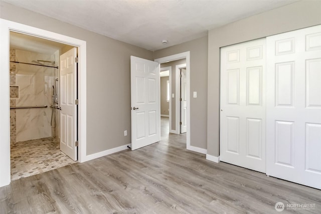 17801 111th Ave SE, Renton, WA 98055 - unfurnished bedroom featuring wood finished floors, connected bathroom, a closet, and baseboards