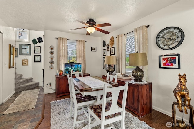 1656 Bishop Rd, Chehalis, WA 98532 - dining space with a textured ceiling, ceiling fan, stairs, baseboards, and dark wood-type flooring