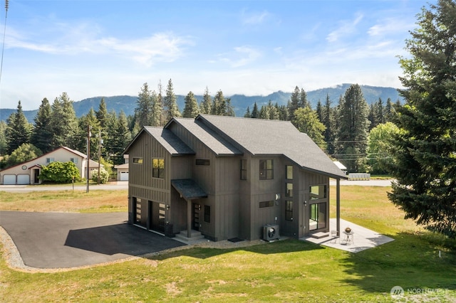 91 Pebble Beach Dr, Cle Elum, WA 98922 - rear view of property with a yard, a mountain view, and a garage